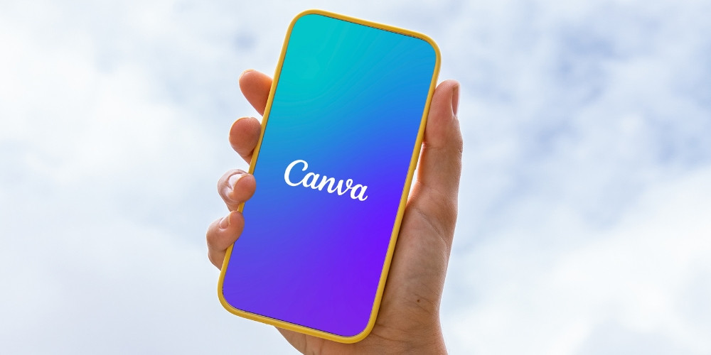 outdoor youths tech person holding phone with canva app